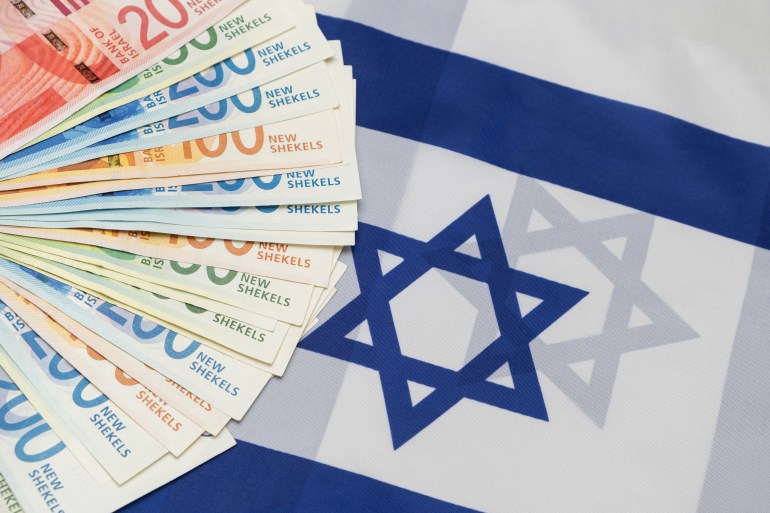 New Israeli shekels banknotes with various nominals. Fan of NIS New shekel laying on israel national flag