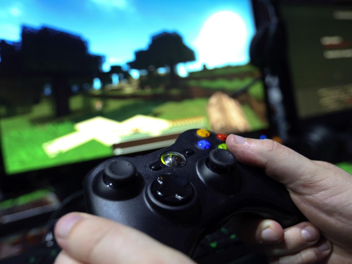 A visitor holds a hand control unit as he plays the Minecraft computer came, produced by Mojang AB, on a Microsoft Corp. Xbox One games consoles during the EGX gaming conference at Earls Court in London, U.K., on Thursday, Sept. 25, 2014. Sony Corp. will begin selling its PlayStation TV set-top box in the U.S. and Europe next month with almost 700 games available, including select Angry Birds, Borderlands, Lego and FIFA soccer titles.